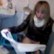 A British girl is filmed by her friends as she finishes peeing on the toilet and wipes herself.